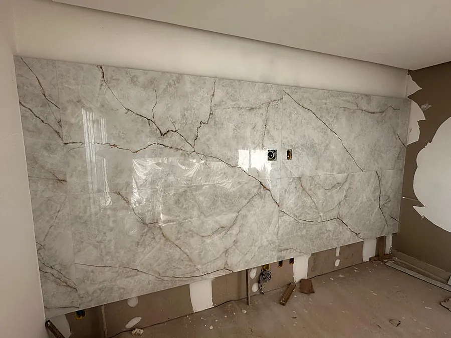 Porcelanato de grande formato sendo assentado na parede